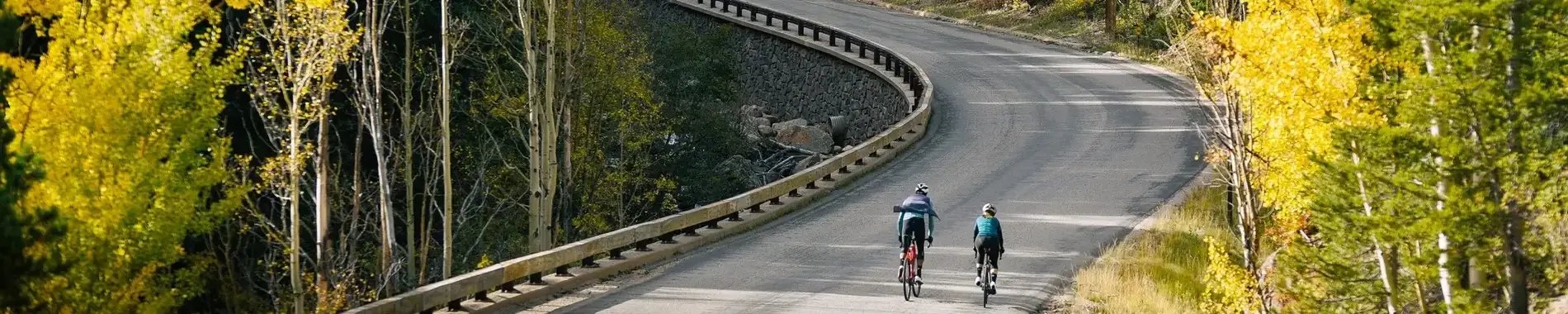 Two road cyclist riding on a mountain road in PEARL iZUMi kits