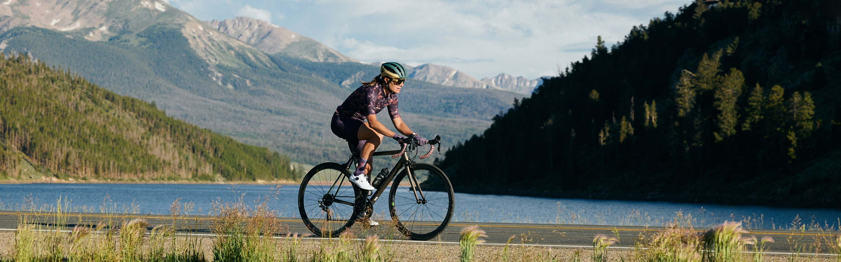 Cyclist in Purple Jersey Riding Through Scenic Area