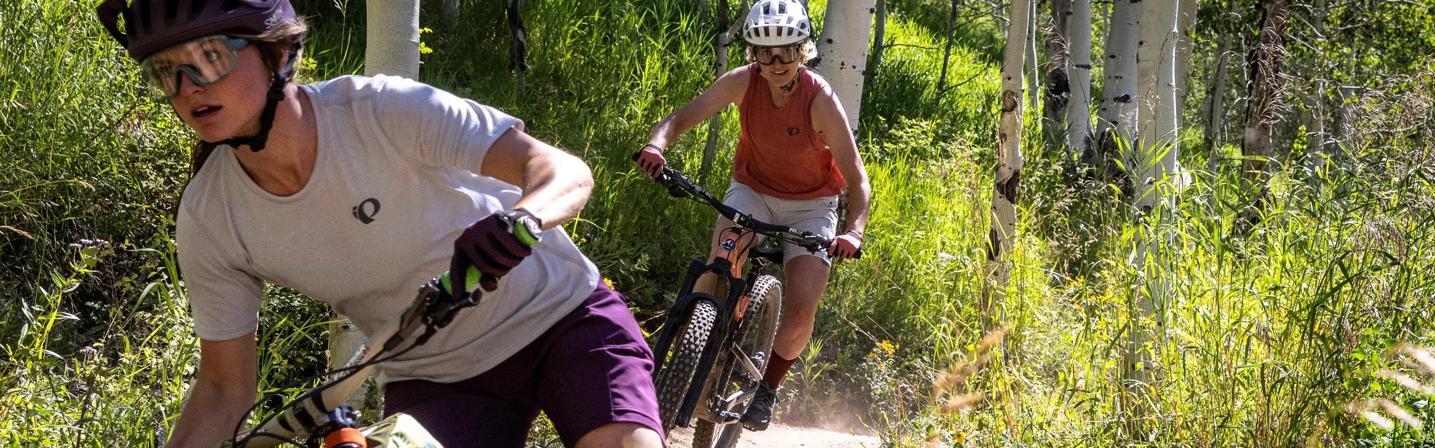 Mountain Biker in Blue Jersey Riding Through Woods