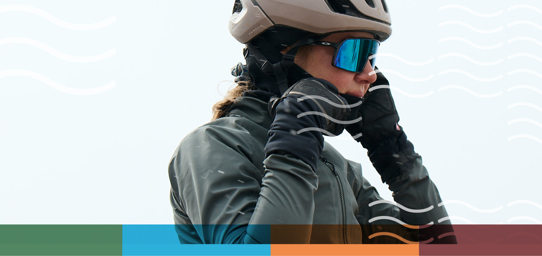 Cyclist Putting On a Neck Gaiter During a Cold Weather Ride