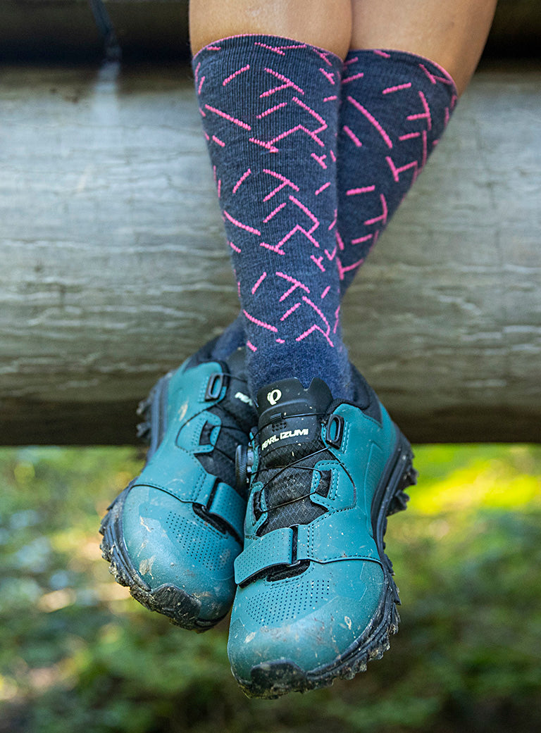 Close Up Shot of Mountain Biker Sitting Down with PEARL iZUMi Shoes and Socks On