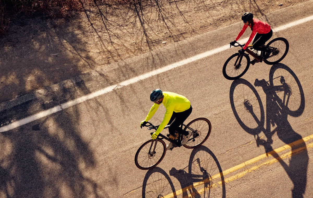 Aerial image of two road cyclist riding on a paved road