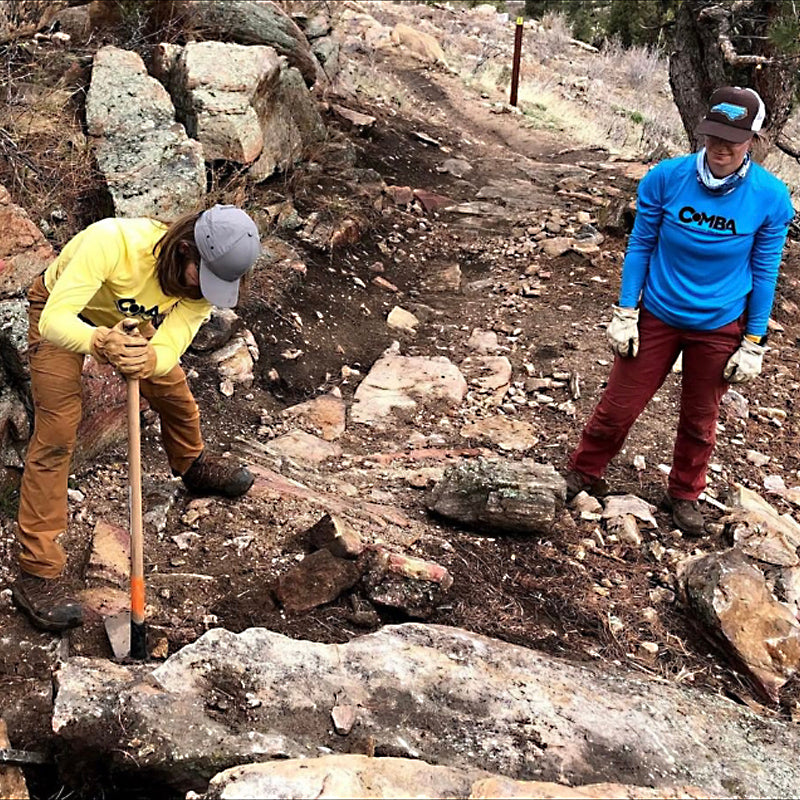Mountain Bike Riders Doing Trail Work With Hand Tools