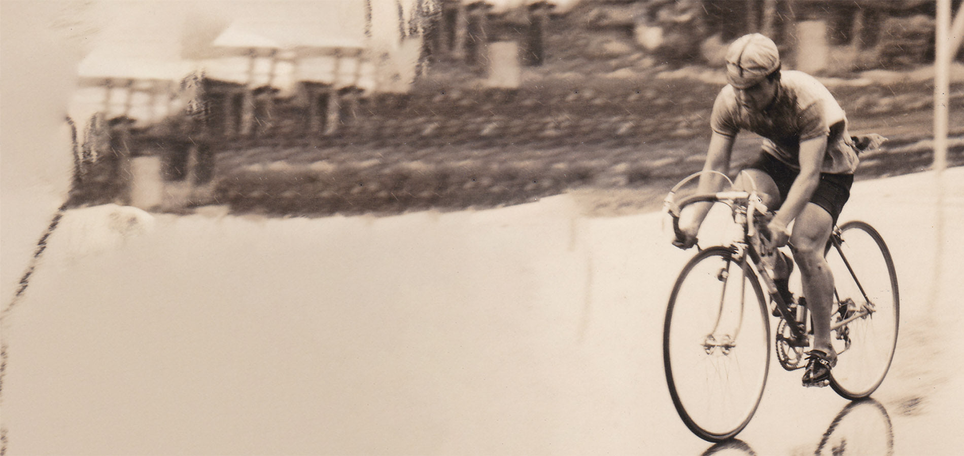 Man riding a road bike from a time in the past.