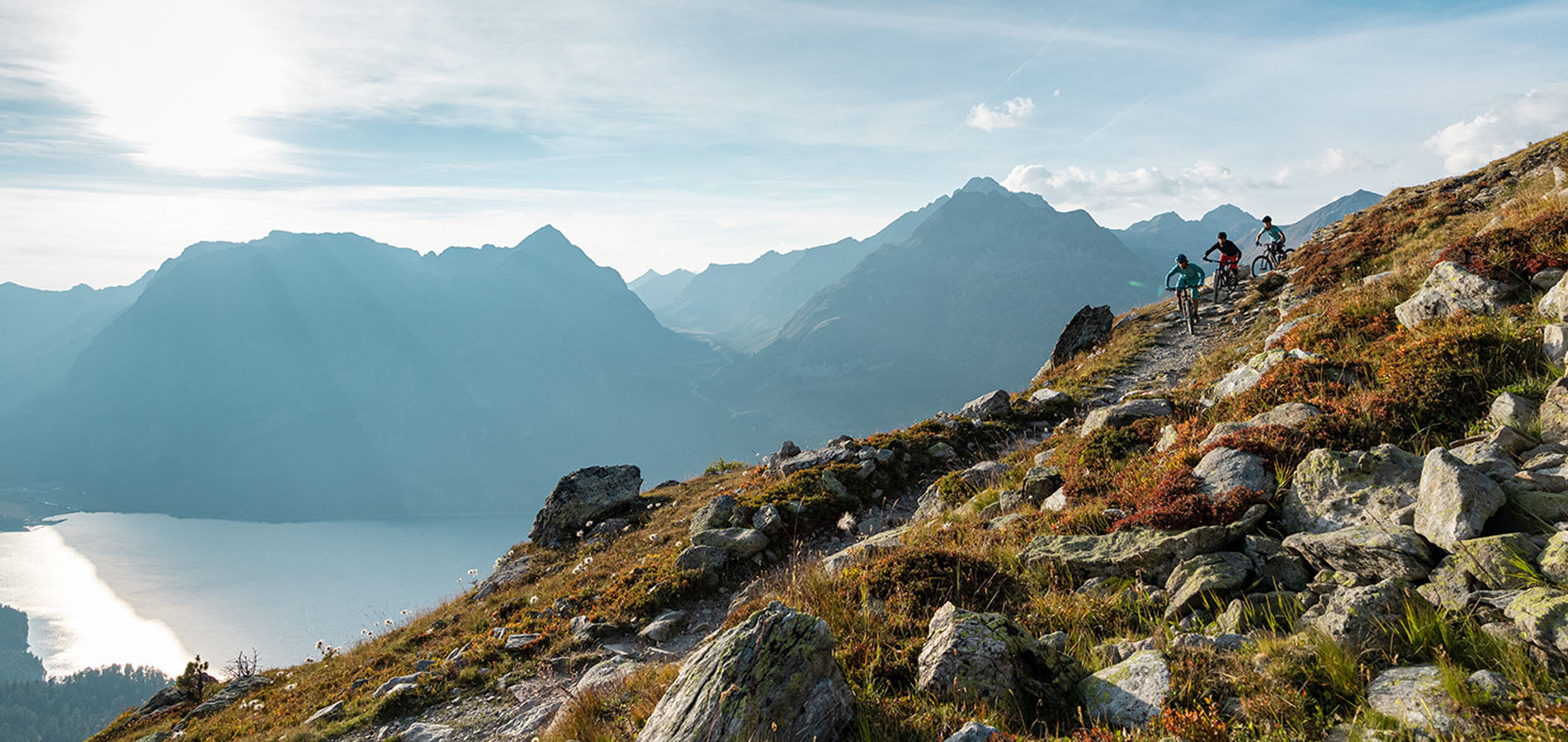 Mountain Bikers Riding Down a Technical Trail Above Tree Line