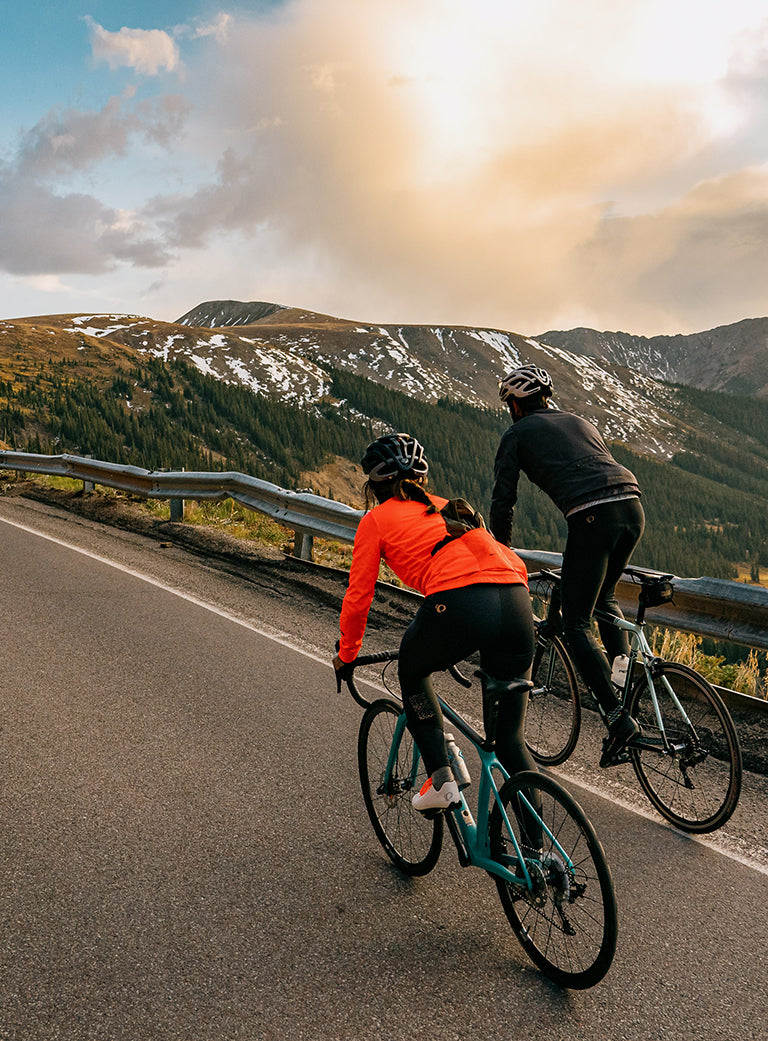 Road Cyclists Climbing Up a Road in the Fall