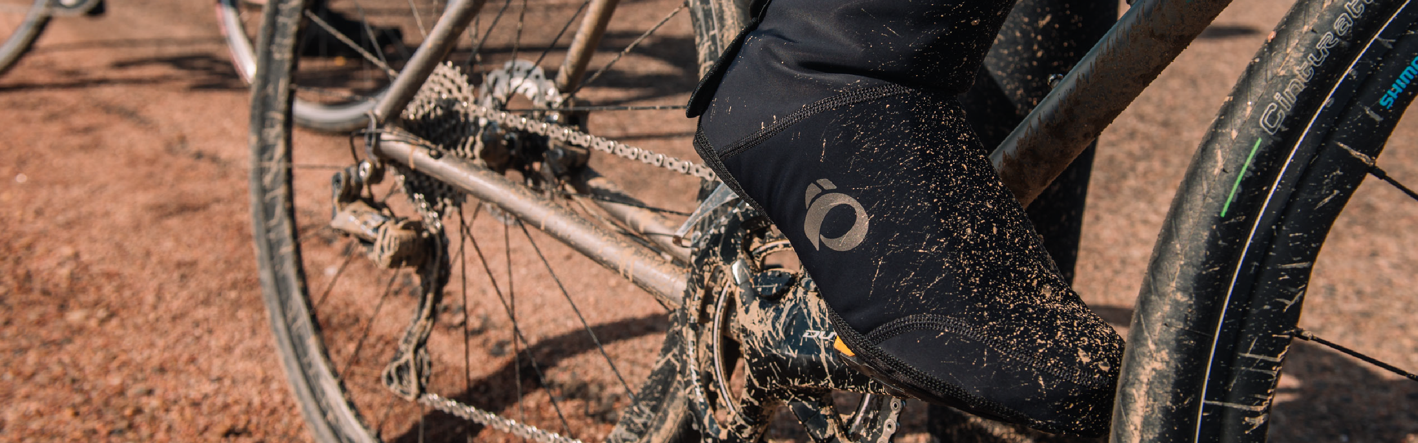 Rider Wearing Cycling Shoe Covers on Muddy Terrain