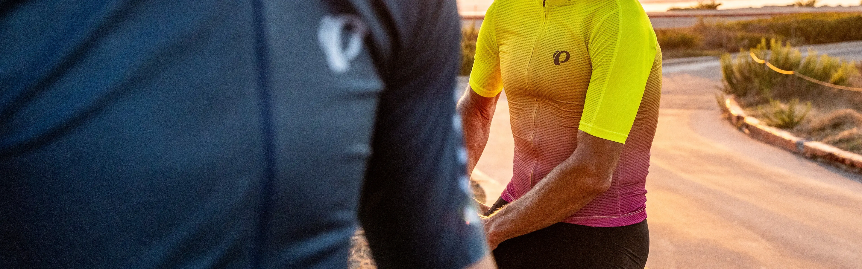 cyclist standing over bike, wearing Pearl Izumi thermal gloves and thermal bib tights