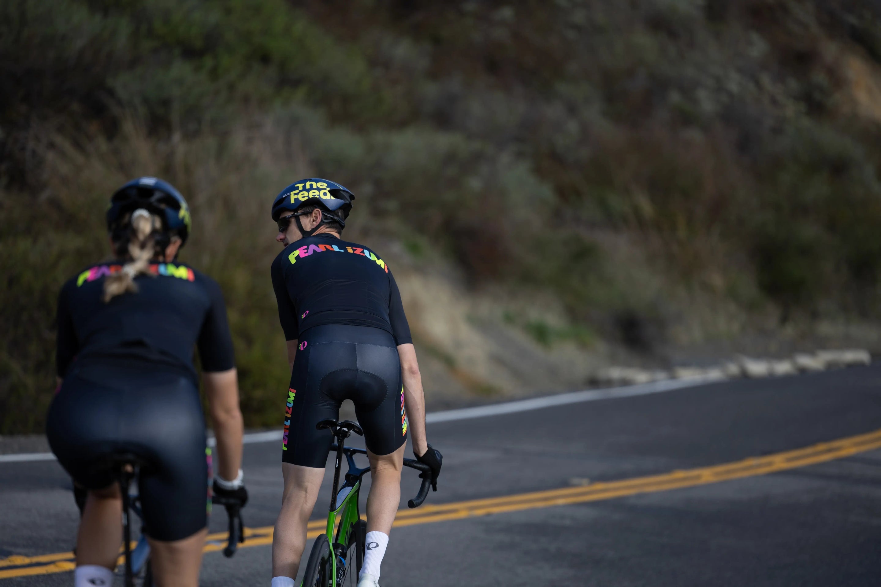 two bicycle riders in PEARL iZUMi cycling apparel