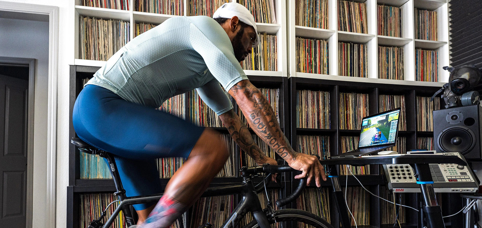 Male riding inside on a trainer while wearing PEARL iZUMi cycling apparel