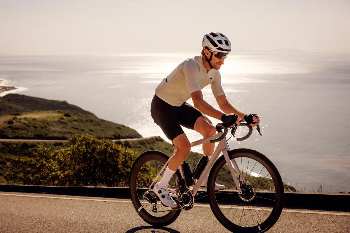 Cyclist riding on a road with a scenic background