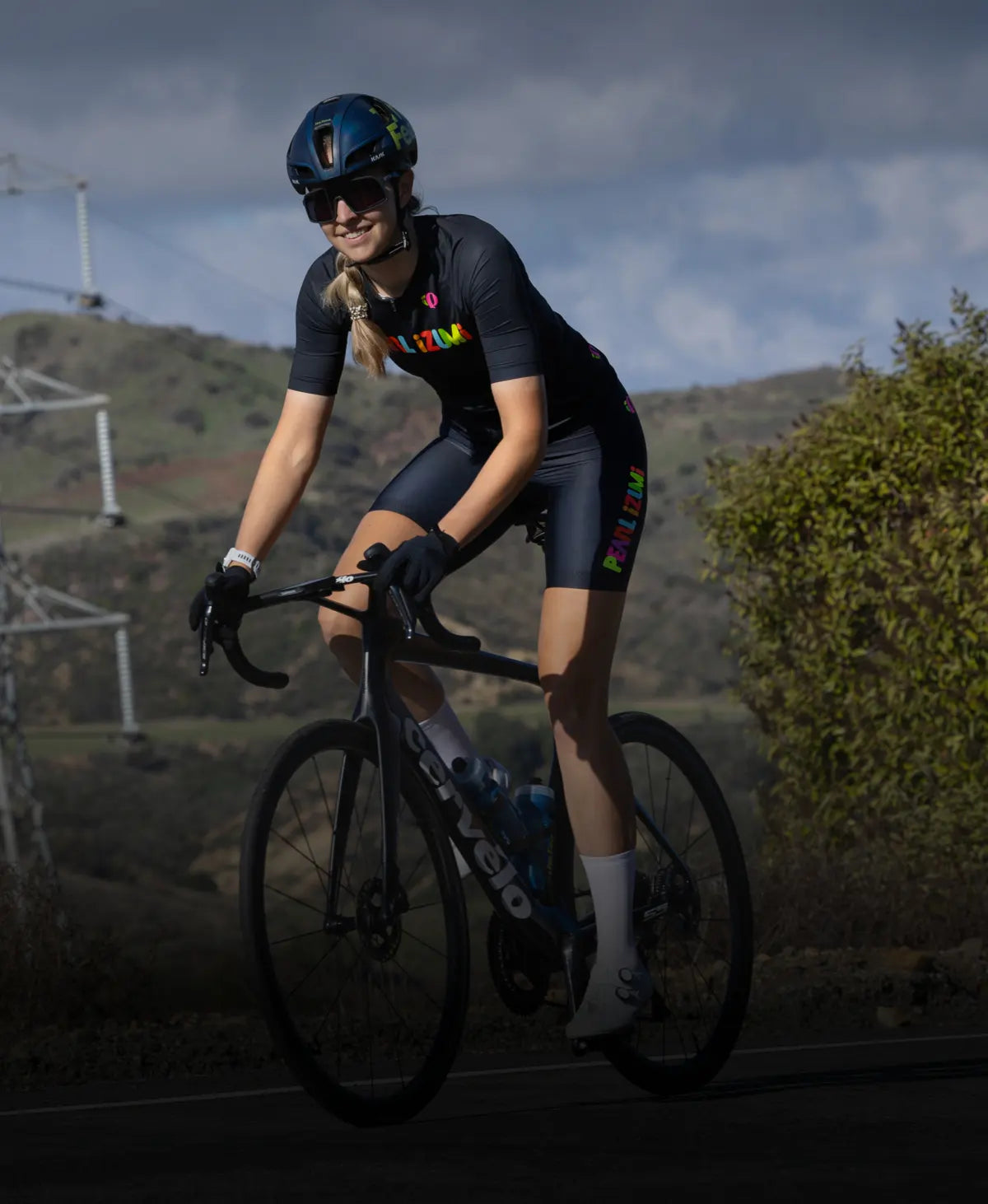 Cyclist riding her bike wearing PEARL iZUMi BioViz gear