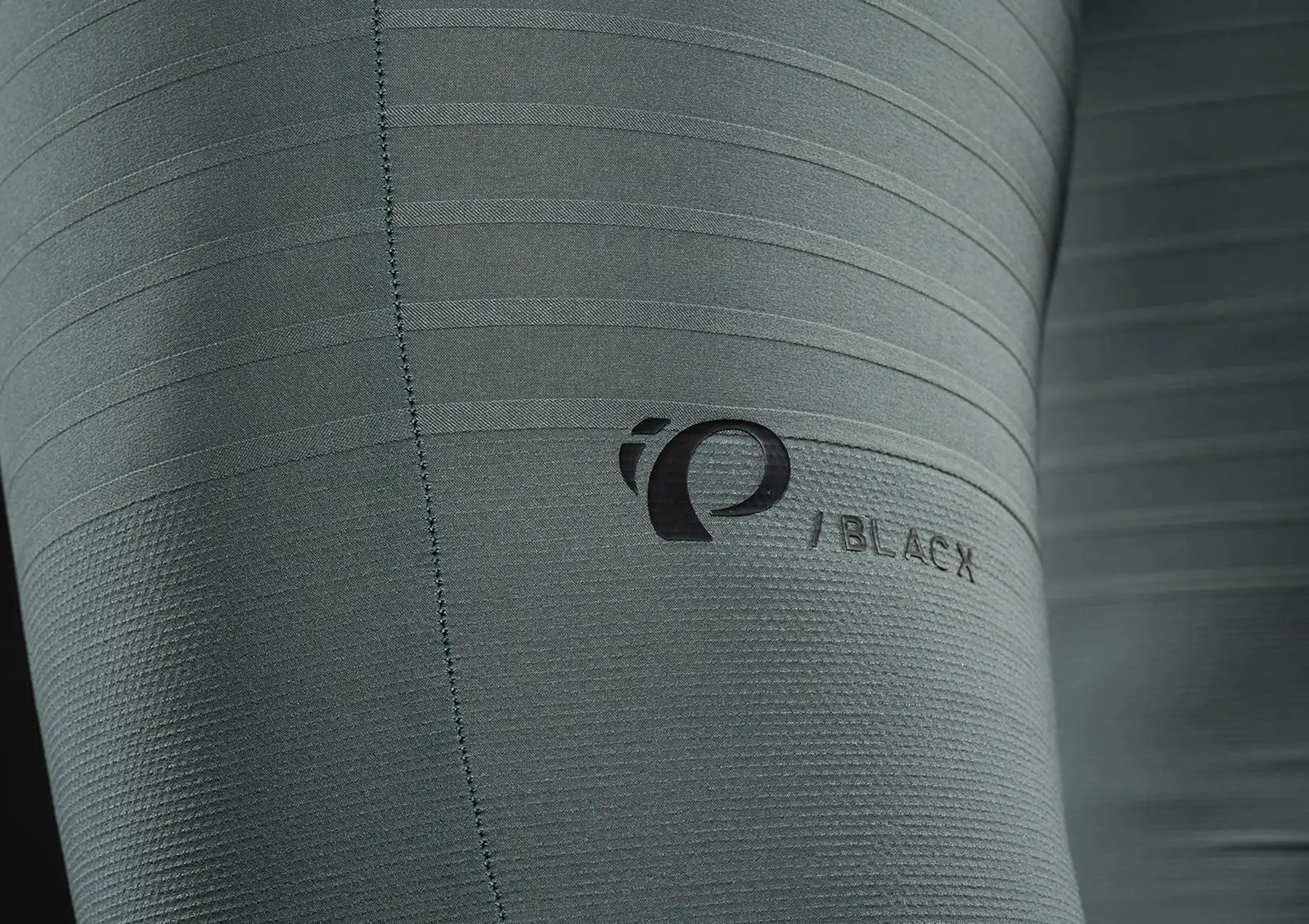 Close-up of a gray textured surface with a brand logo.